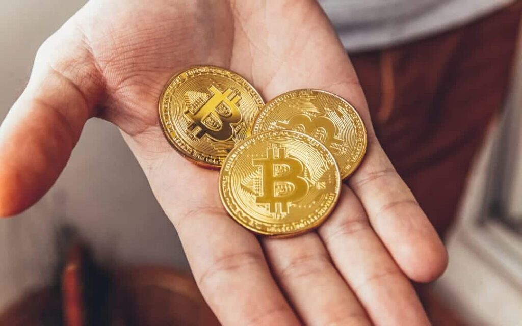 Man Hand Holding Cryptocurrency Coins